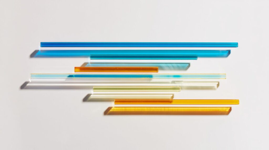 Translucent glass rods of different lengths floating above a white surface casting soft shadows, reimagining a Gantt chart of a blockchain project.